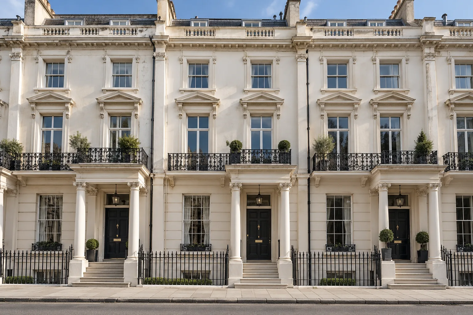 Concept image: cream Italianate terrace with columned entrances, sash windows and black railings